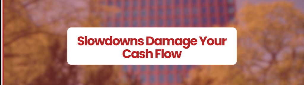 Backgroud of buildings in summer with green leaf trees. White box in centre of image which says' Slowdowns Damage Your Cash Flow'